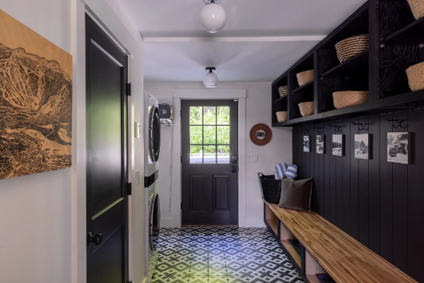 Mudroom hallway with built-in bench, storage, and patterned tile floor